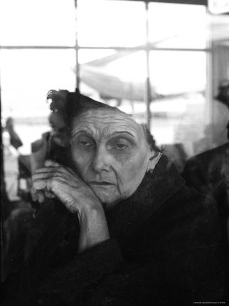 Elderly Cuban Woman in Airport Watching Family Leaving Due to Revolution