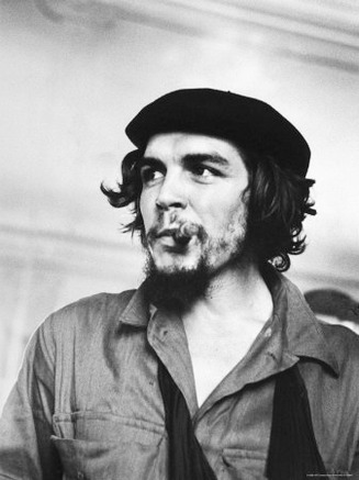Cuban Rebel Ernesto Che Guevara with Lit Cigar Clenched Between Teeth and Left Arm in a Sling