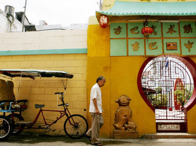 An Unidentified Chinese Man Walks Past the Cuban Wushu Association of Havana's Chinatown